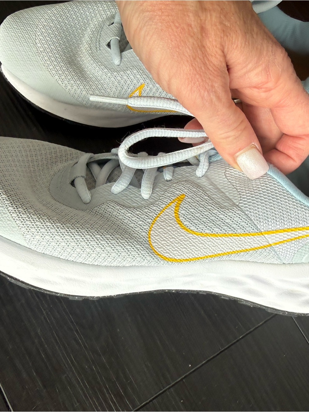 Nike Women's Pale Blue Athletic Shoes with Yellow Swoosh